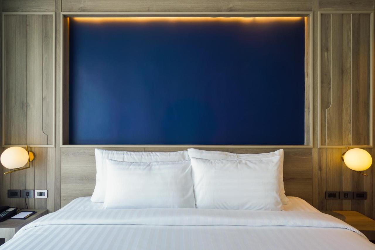 Seabed Grand Hotel Phuket - Sha Extra Plus Экстерьер фото A bed with two pillows